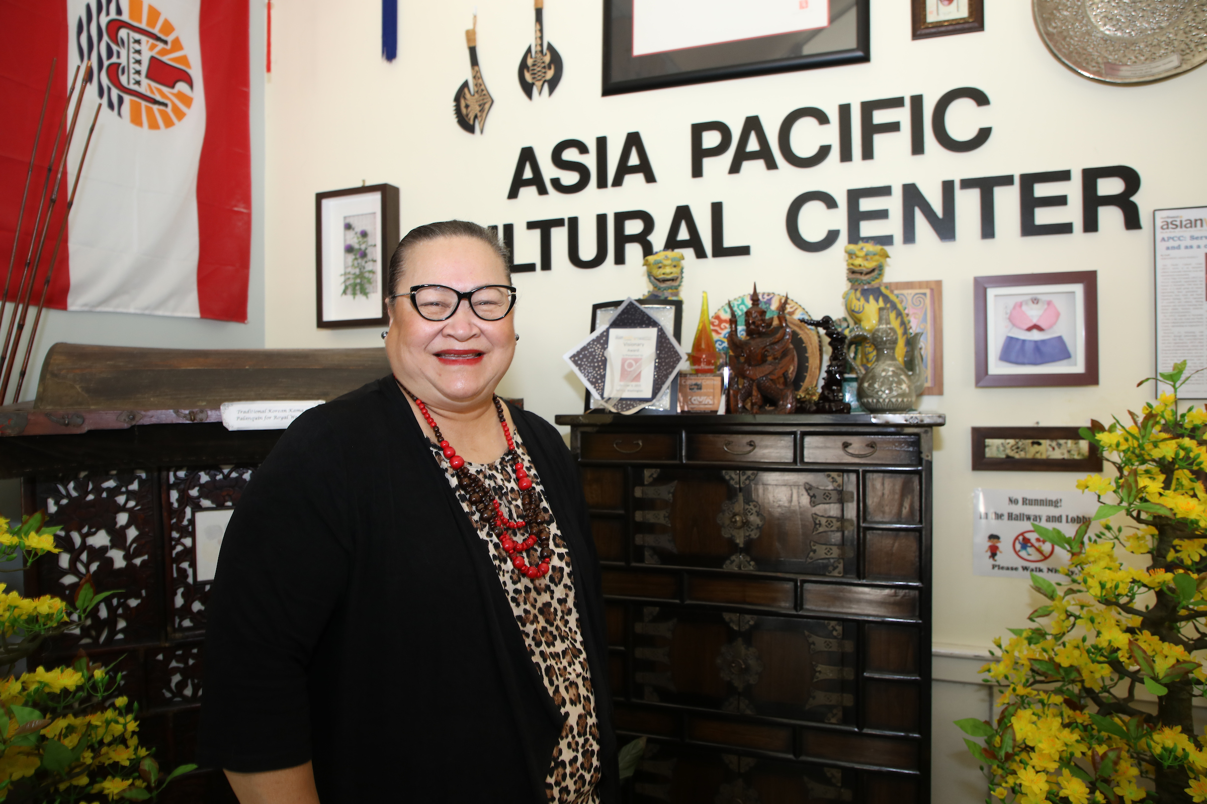 photo of a woman standing in front of a wall reading Asia Pacific Cultural Center