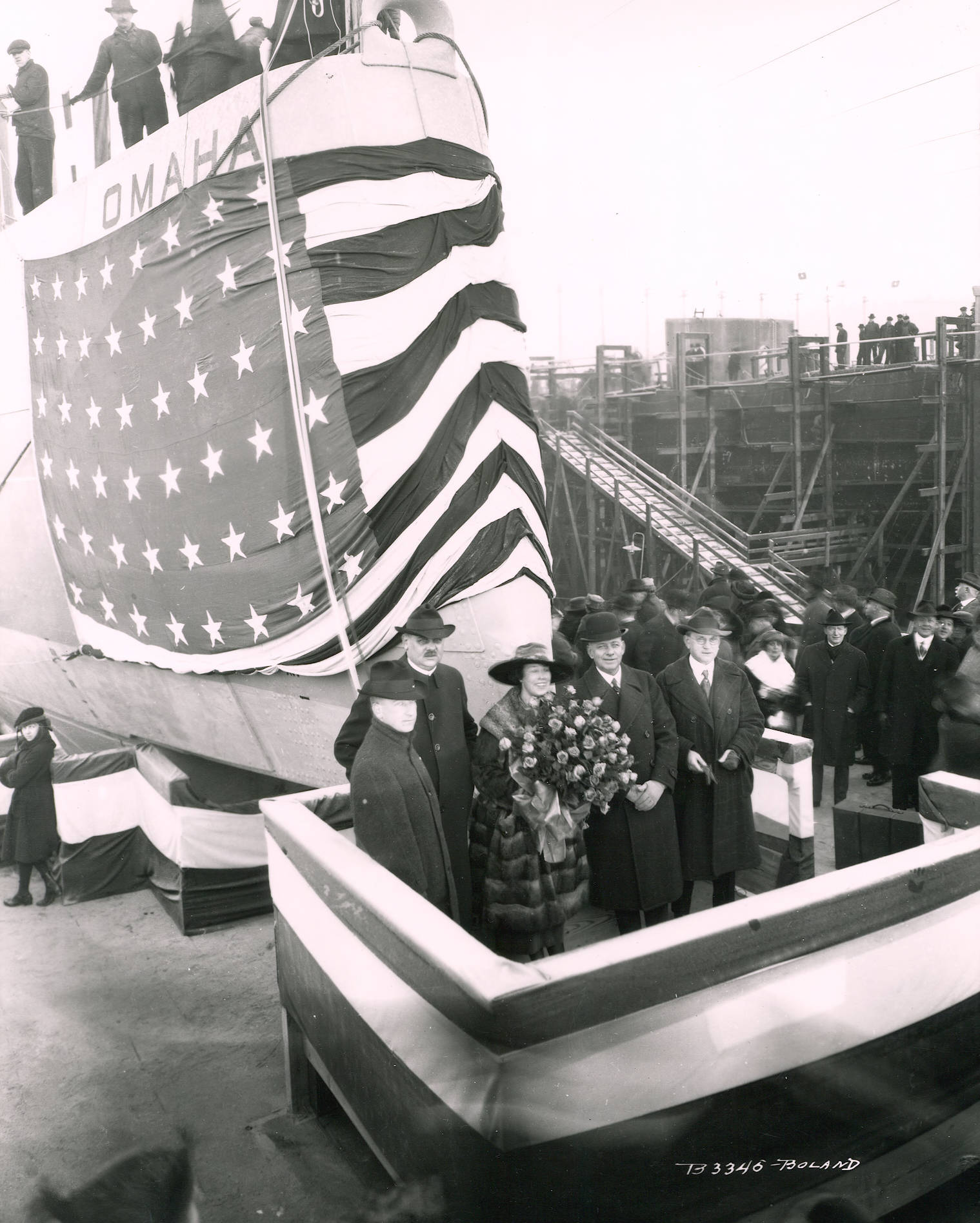 photo of people standing in front of a ship with American flag